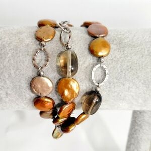 Triple strand brown beaded and silver rings bracelet
